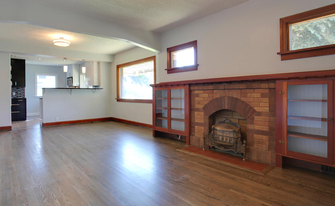 Kept existing character in woodwork, refinished the hardwood, opened up the kitchen to the main living space and adding an eating bar.
